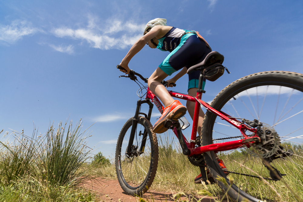 woman mountain biking in the sun