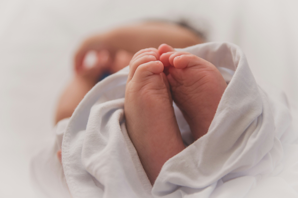 a content and healthy baby in a mother's arms, symbolizing the positive impact of vitamins on breastfeeding moms. The picture conveys the importance of proper nutrition, highlighting the role of essential vitamins in supporting both maternal well-being and the health of the nursing baby