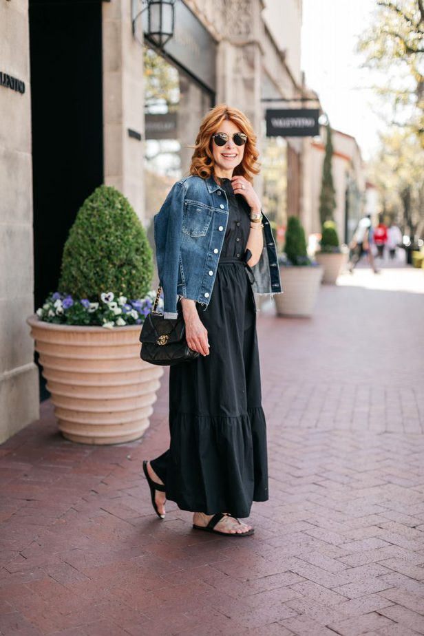 woman walking and wearing AFFORDABLE BLACK DRESS FOR SPRING and denim jacket