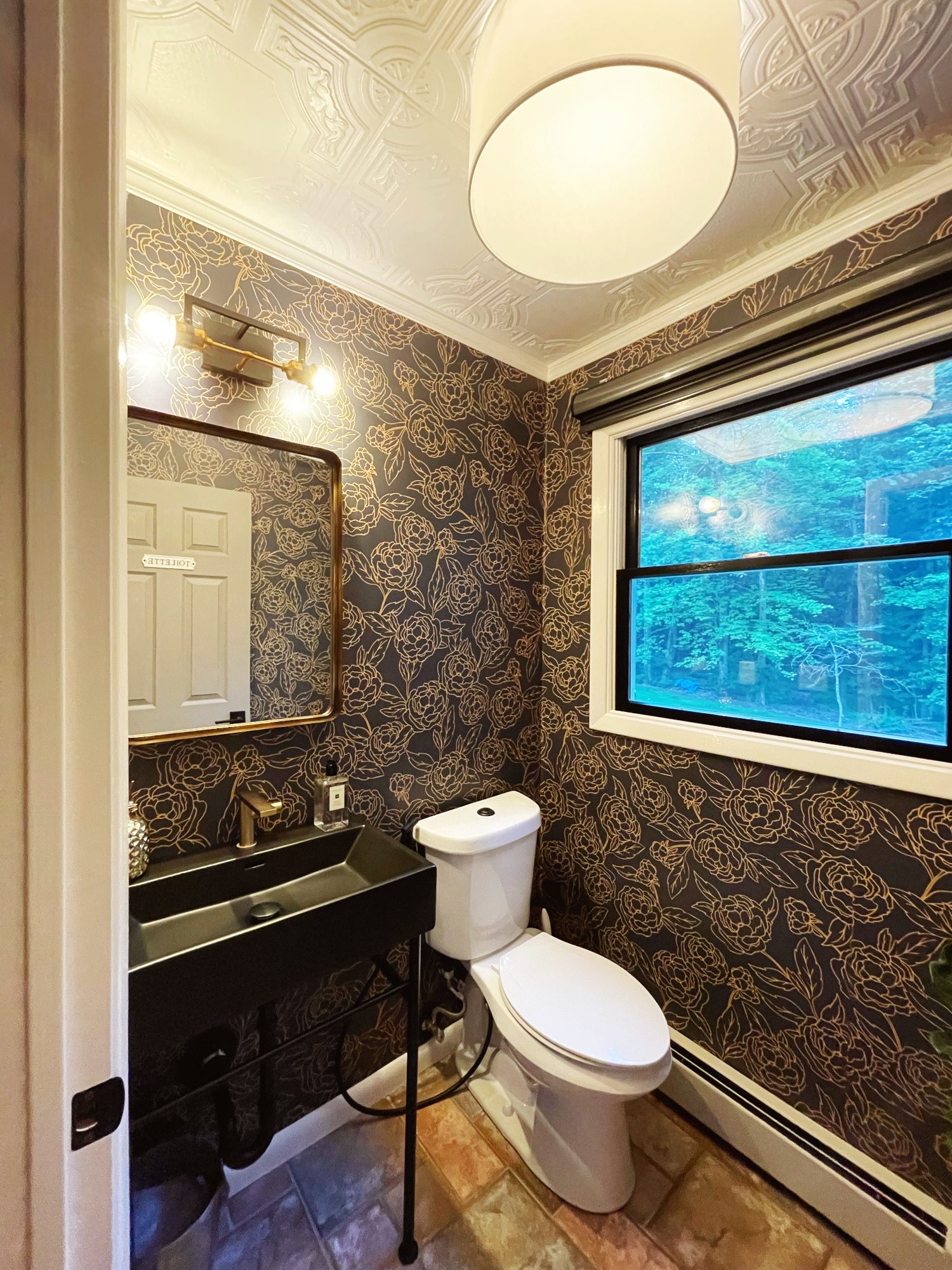 black gold floral wallpaper, powder room, moody powder room, console sink, black vanity, black sink