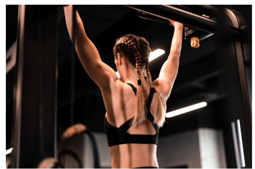 woman hanging on a pull up bar