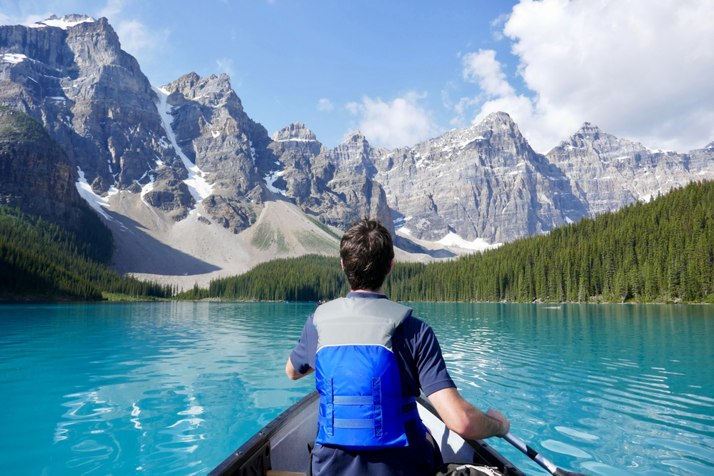 man kayaking in the mountains