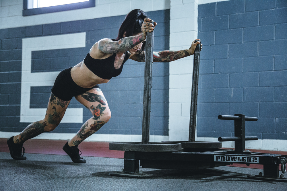 woman pushing weights, gaining muscle mass