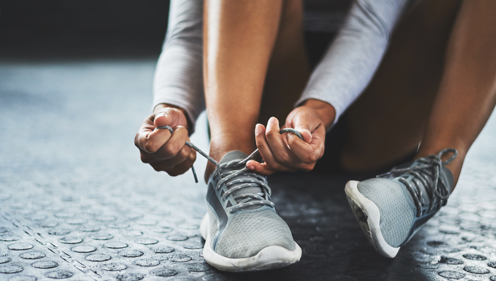 lacing up gym shoes for a run