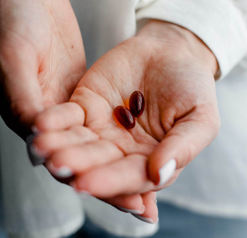Magnesium supplements in a person's hand