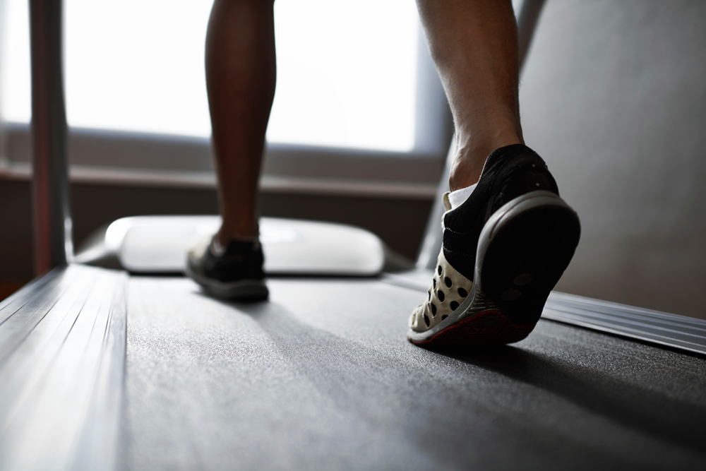 walking on treadmill in an at home gym