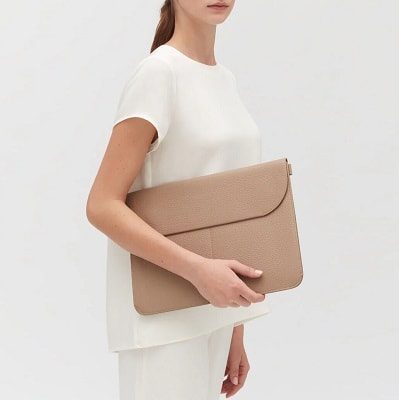 woman holds beige