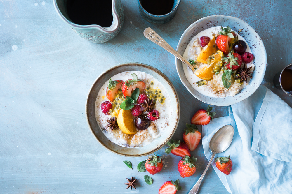 A close-up image of a delicious bowl of oatmeal topped with fresh, vibrant strawberries. The warm and inviting bowl showcases a wholesome breakfast choice, highlighting the nutritious combination of whole grains and sweet berries for a visually appealing and health-conscious meal.