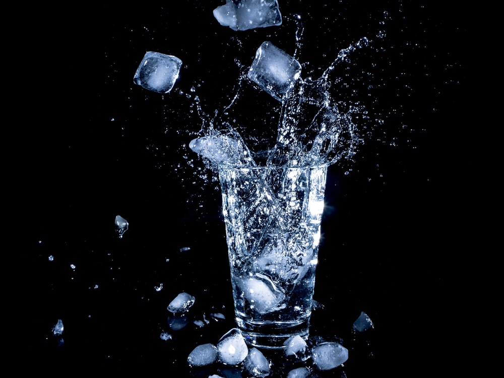 A refreshing image of a glass of ice water, emphasizing the importance of hydration. The clear glass contains ice cubes, and condensation glistens on the surface. The visual underscores the significance of staying well-hydrated for overall health and wellness, promoting a lifestyle focused on proper hydration for optimal bodily functions.