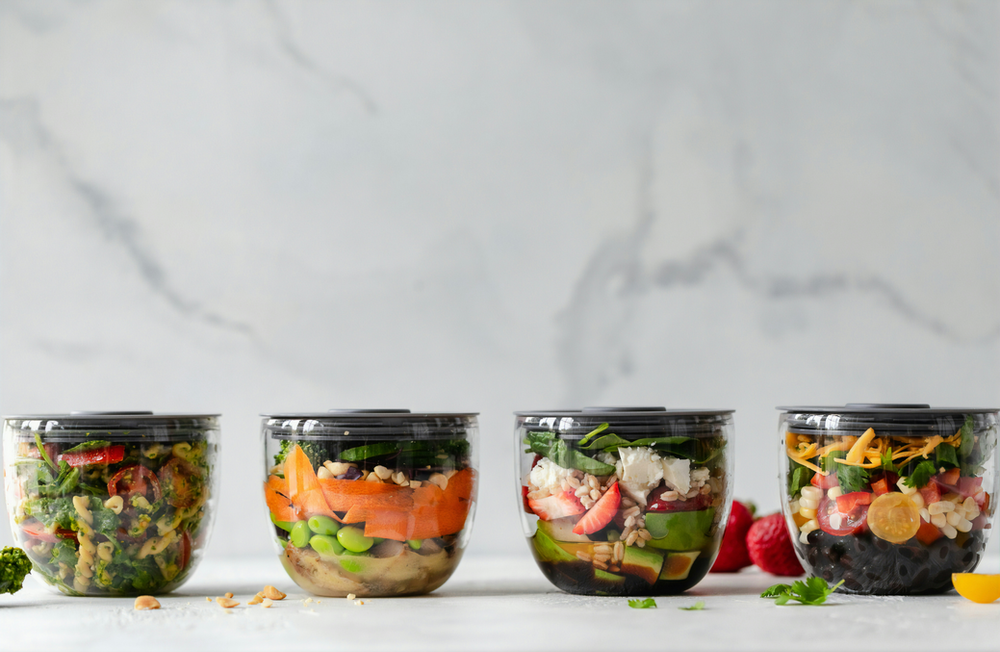  a meal planner template on a table with sections for proteins, fats, and carbohydrates. The planner includes spaces for daily meals, allowing users to organize and track their macro intake effectively. The design is user-friendly with clear categories for easy meal planning