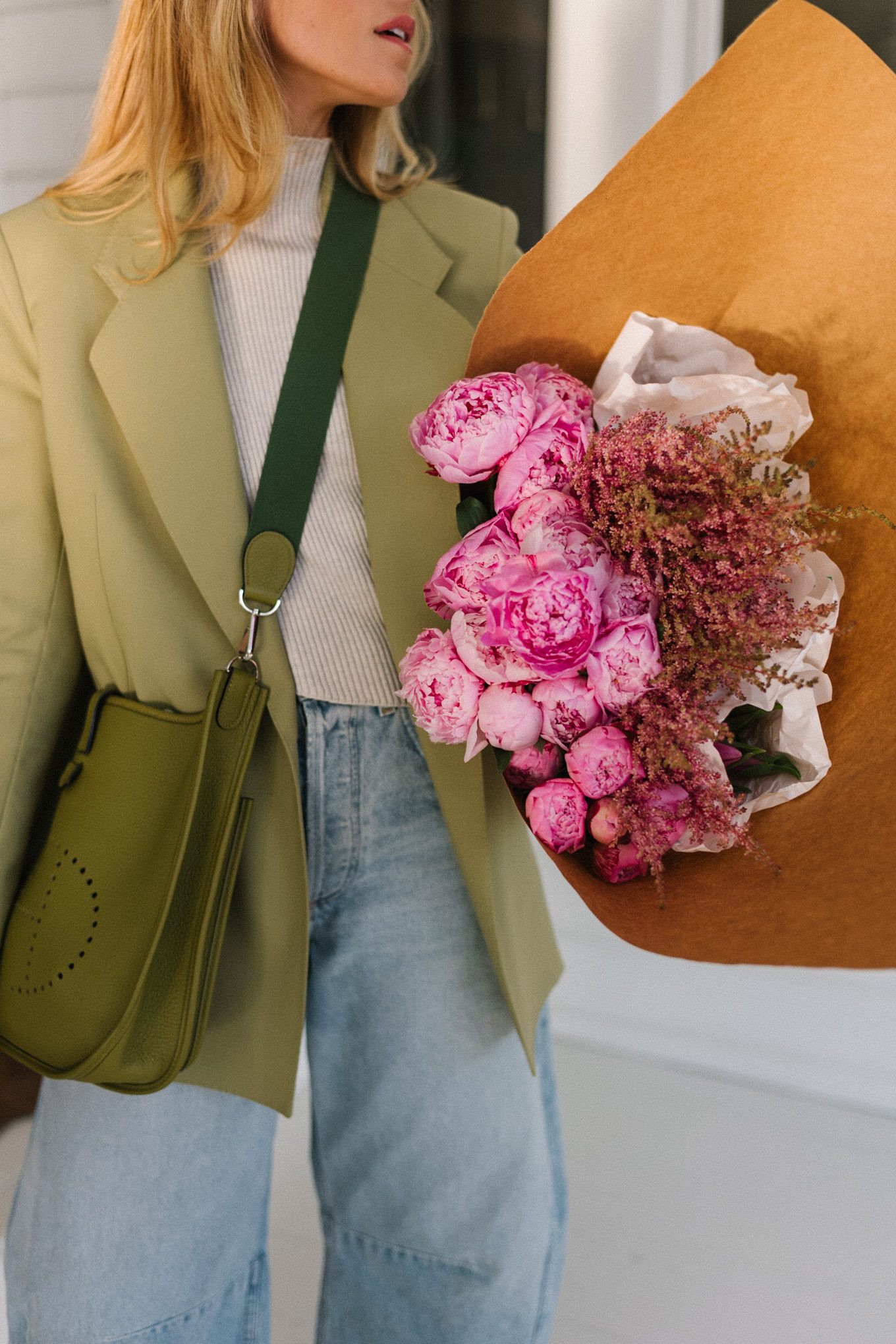 green blazer cream turtleneck blue horseshoe jeans