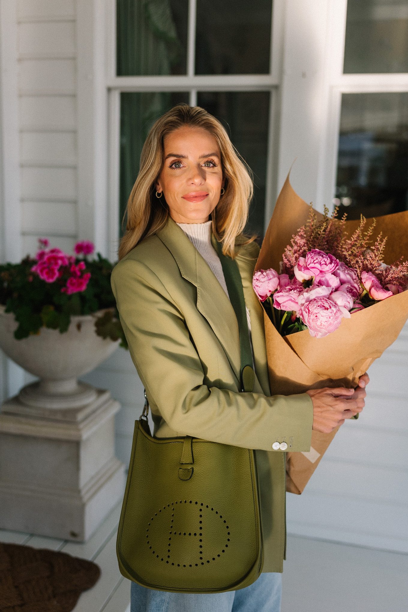 green blazer cream turtleneck blue horseshoe jeans