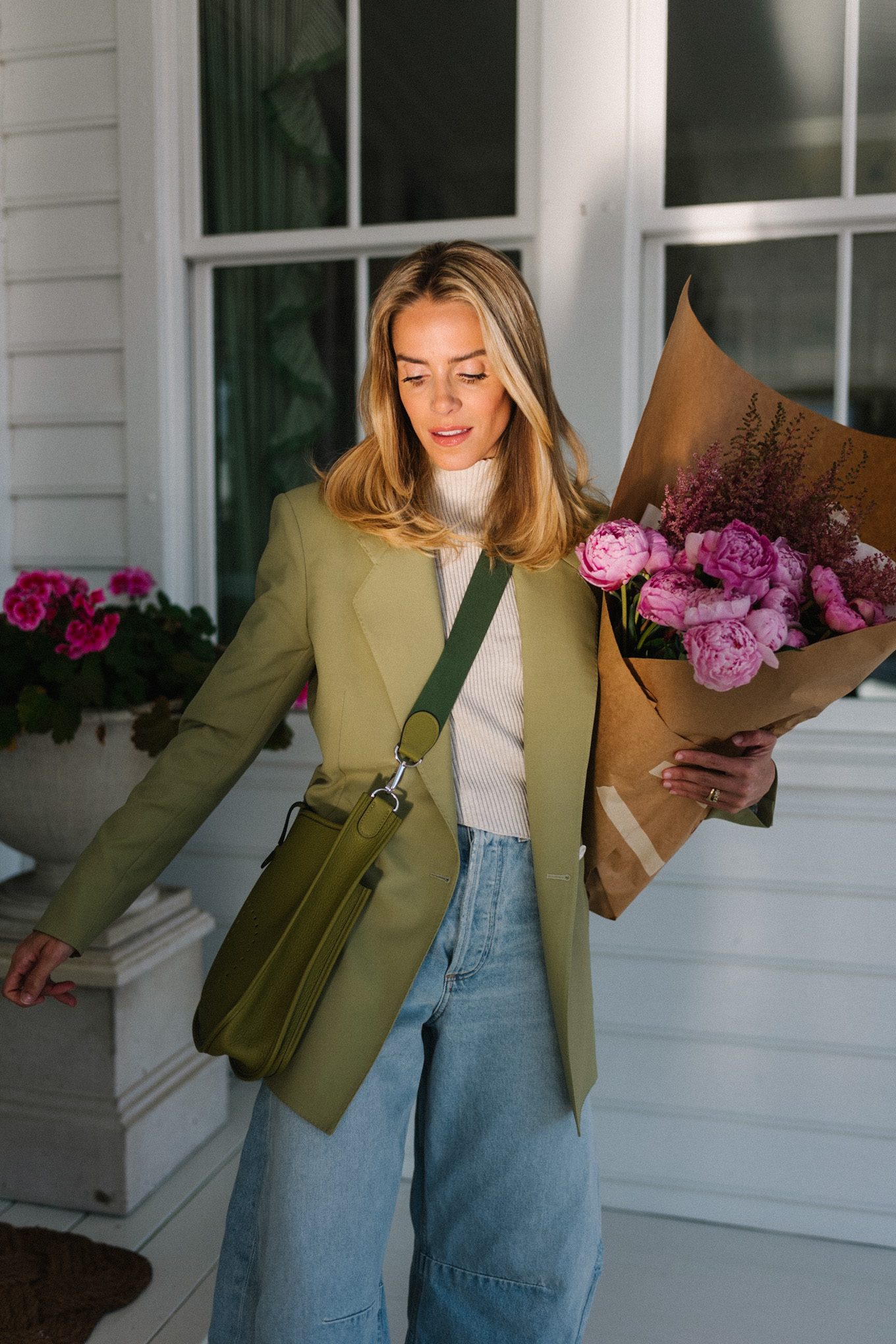 green blazer cream turtleneck blue horseshoe jeans