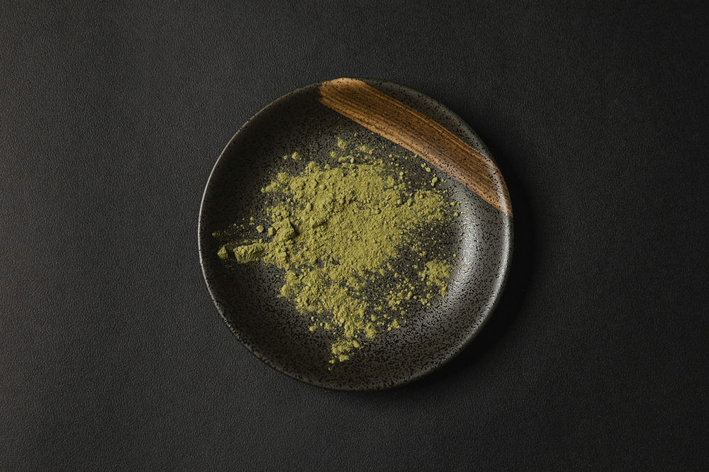  A wooden bowl filled with vibrant green powder, representing green superfood powder, a nutrient-rich supplement.