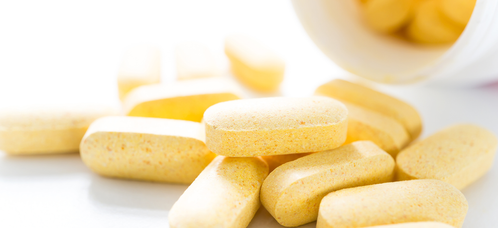 The image depicts biotin supplements in pill form, which are commonly used to support healthy hair, skin, and nails. Biotin, a water-soluble vitamin, is a key ingredient in these pills and is known for its role in promoting overall wellness and vitality.