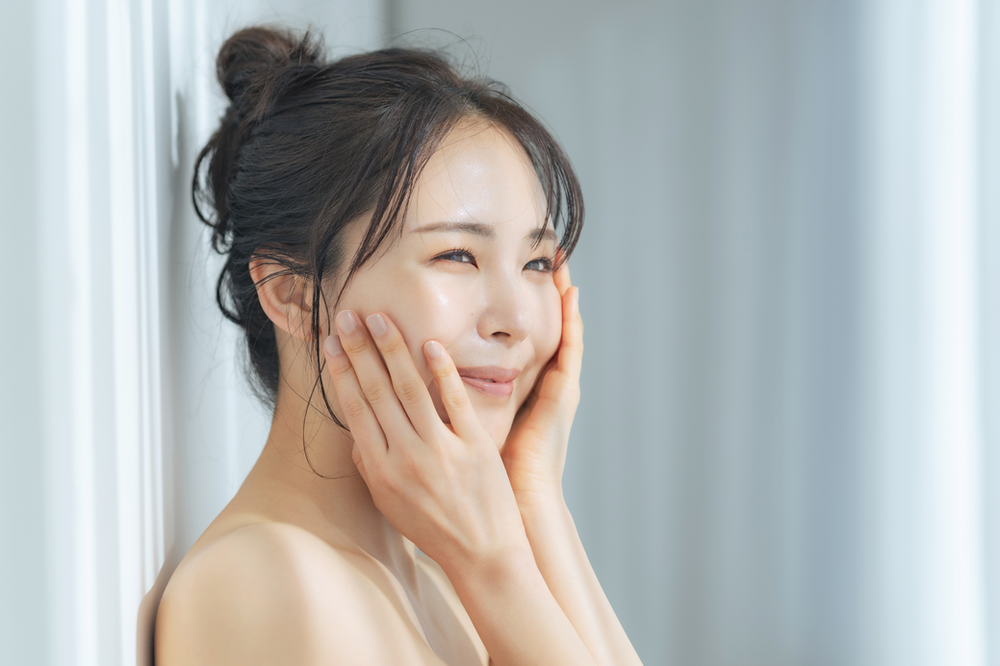 The flawless appearance of the woman's skin may suggest the potential benefits of biotin supplementation. Biotin is known to support healthy skin by promoting cell growth and repair, contributing to a smooth and radiant complexion like the one depicted in the image